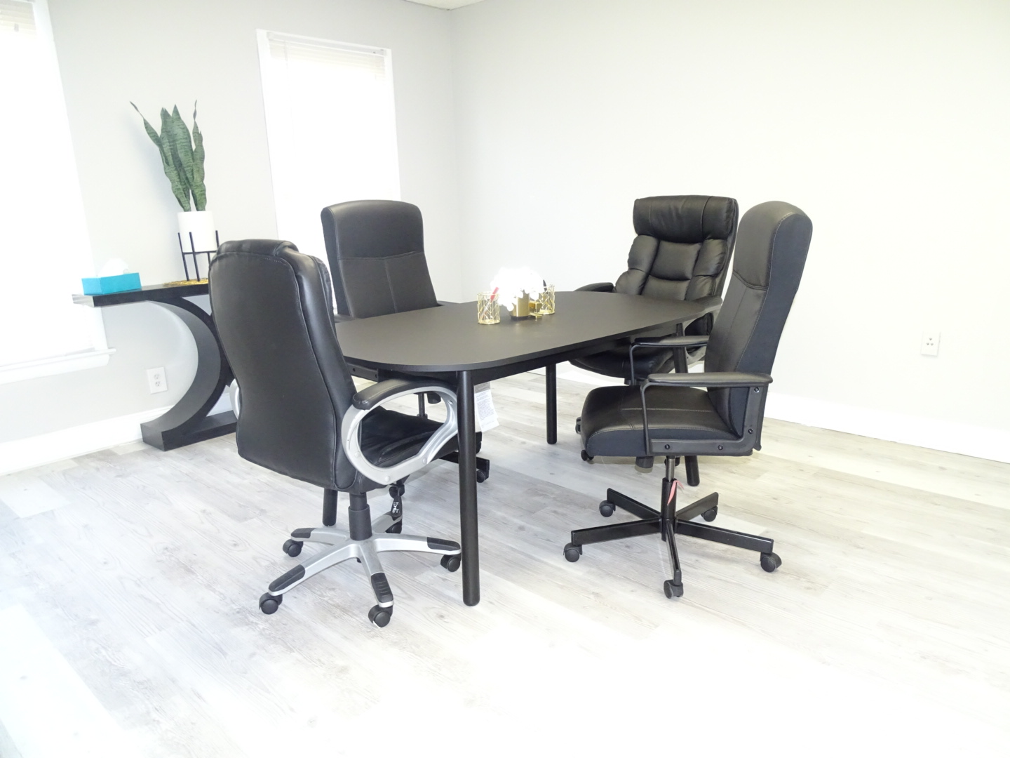 Small meeting table with four office chairs